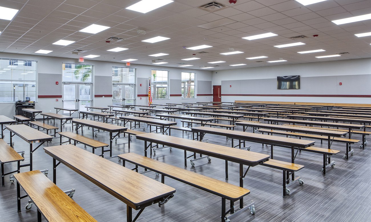 School cafeteria with dining tables and benches