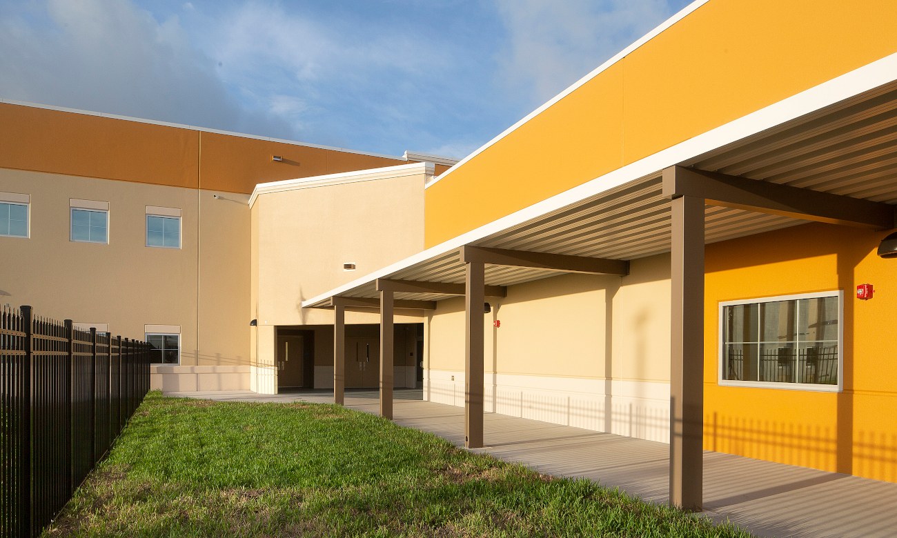School exterior with covered walkway and lawn