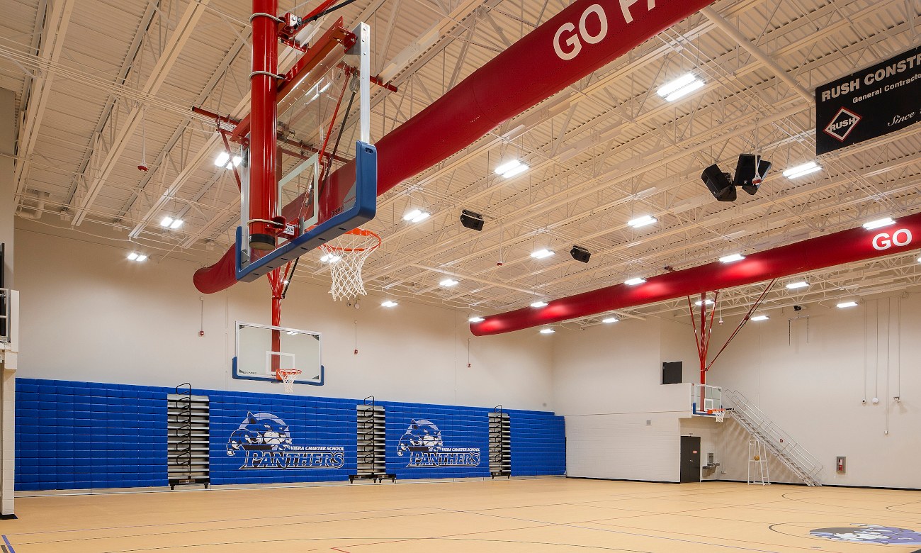 School gymnasium with basketball court and hoop