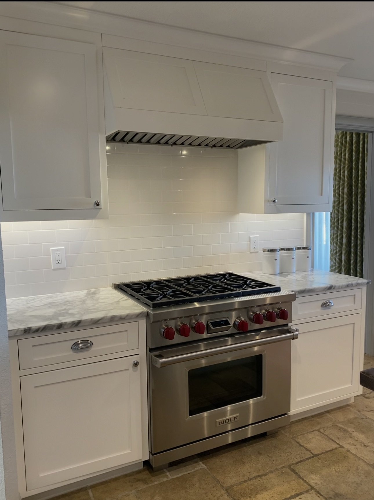 White kitchen with stainless steel range