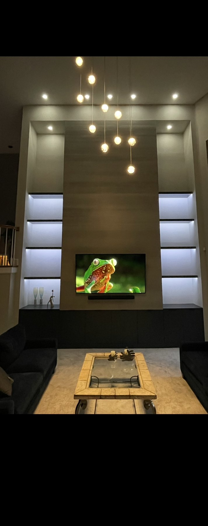 Double-height living room with fireplace and chandelier