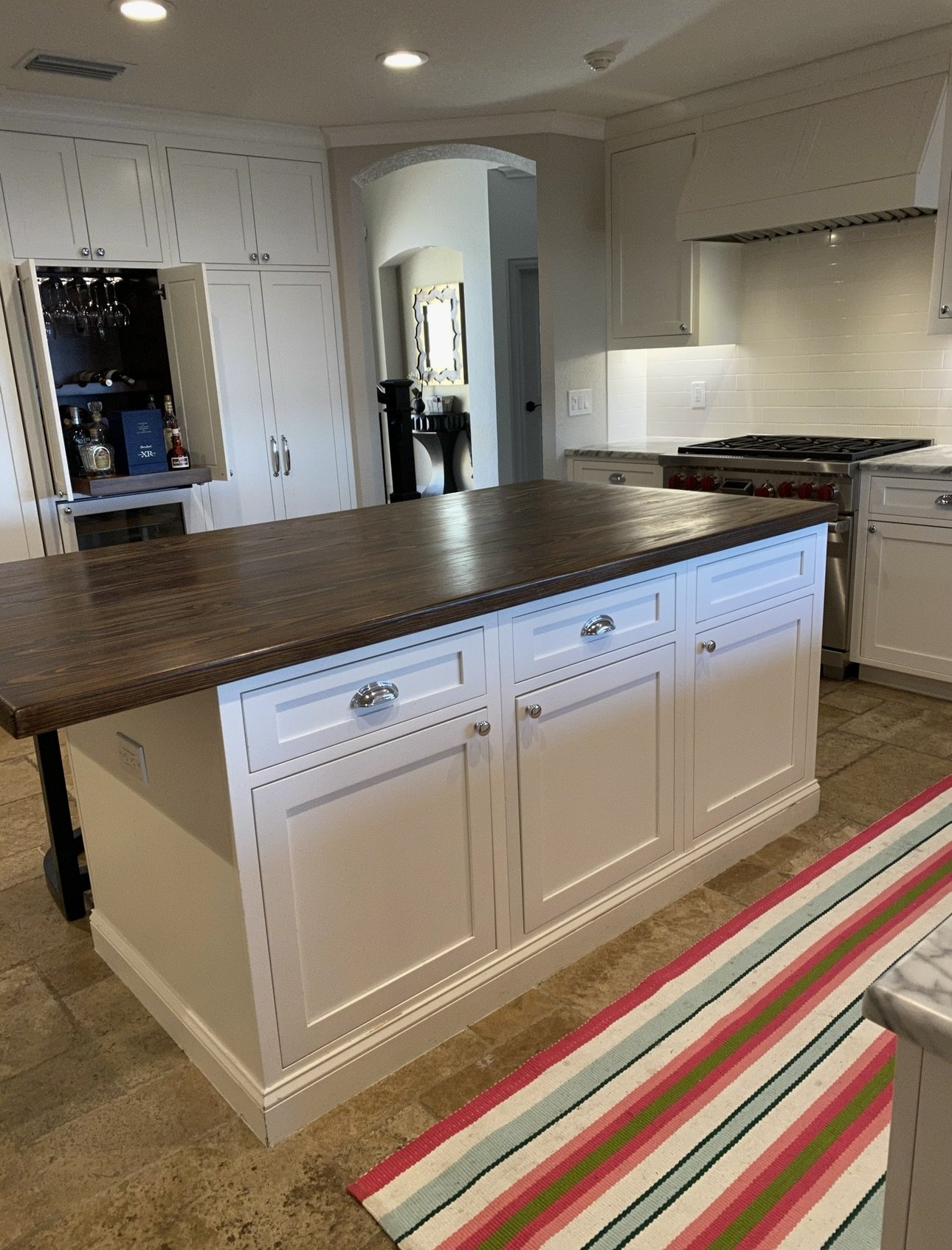 White kitchen island with wood countertop