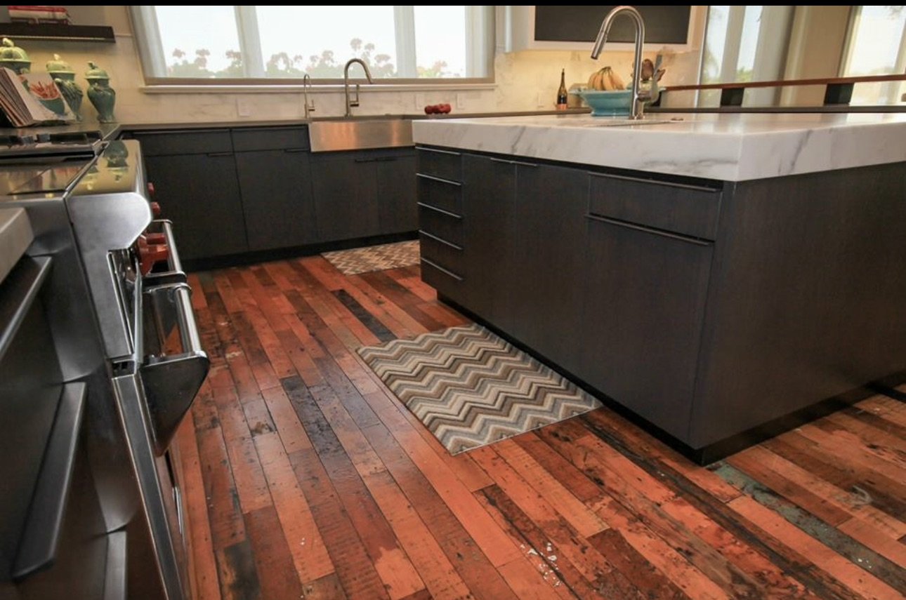 Modern kitchen with dark cabinets and wood floor