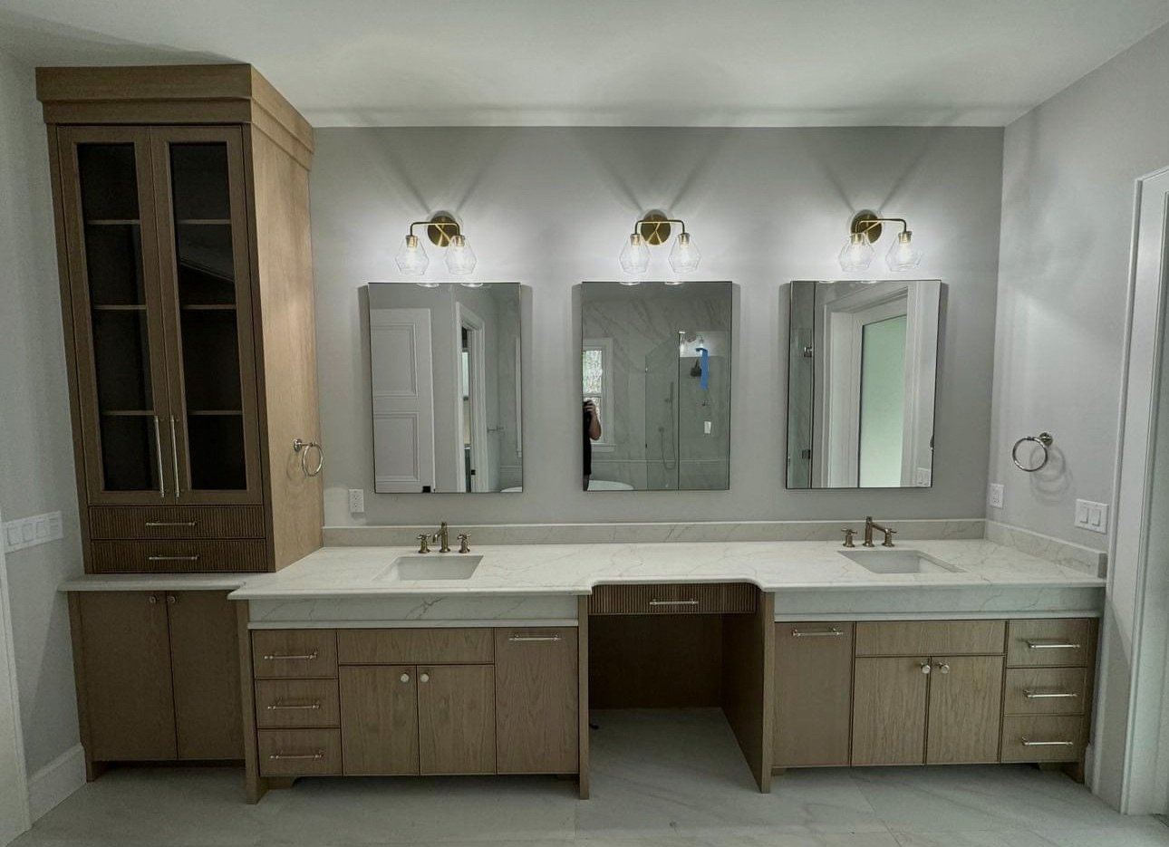 Bathroom with double vanity and illuminated mirrors
