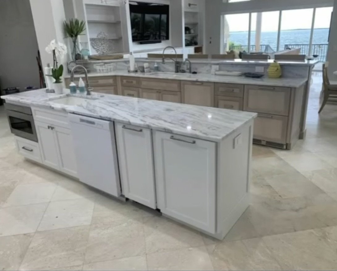 Marble kitchen island with white cabinetry