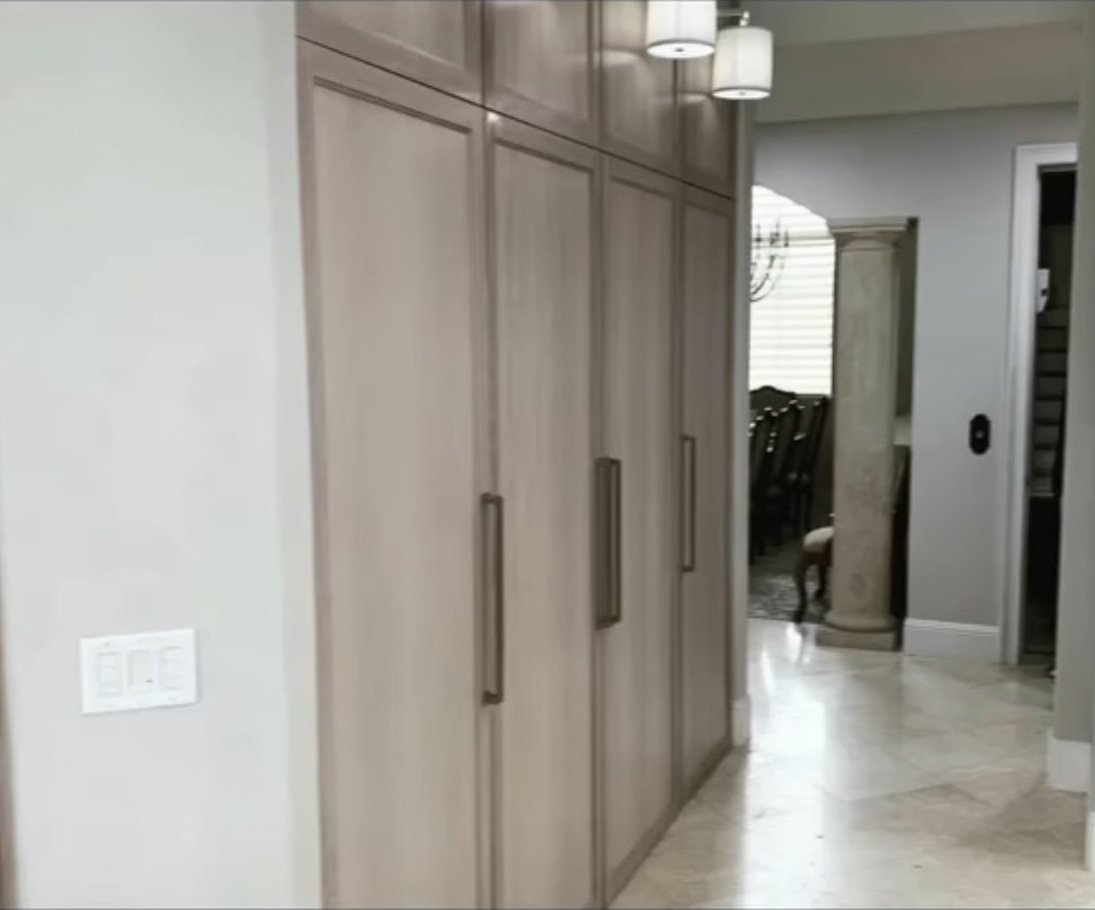 Hallway with floor-to-ceiling storage cabinets