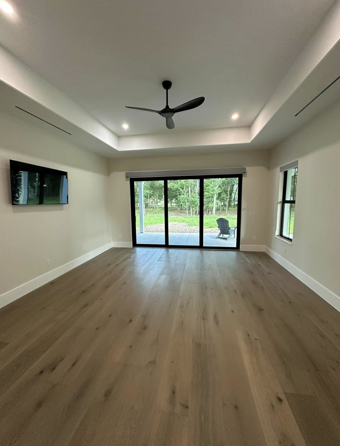 Living room with tray ceiling and sliding glass doors
