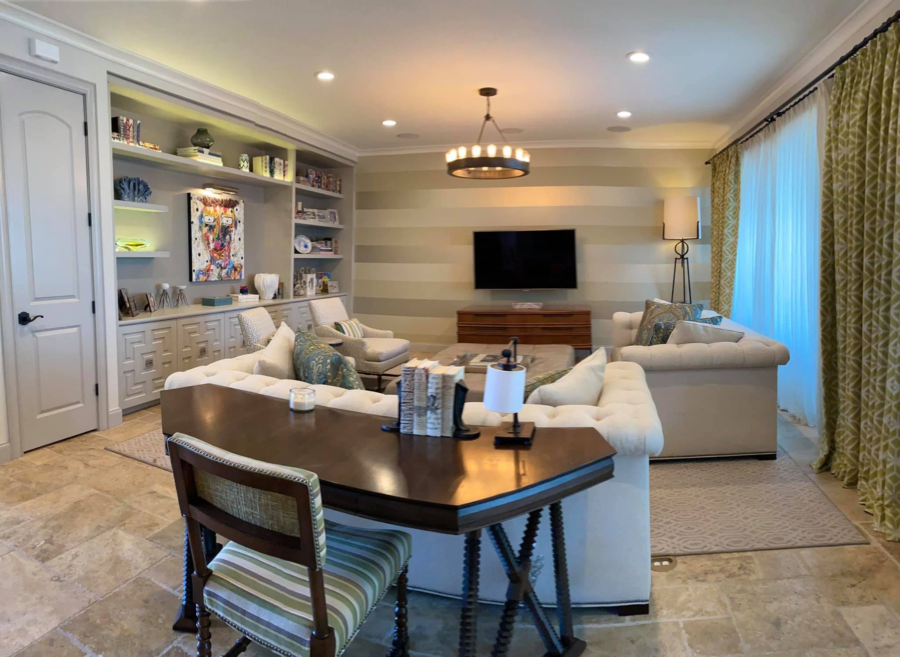 Open living and dining room with custom media wall