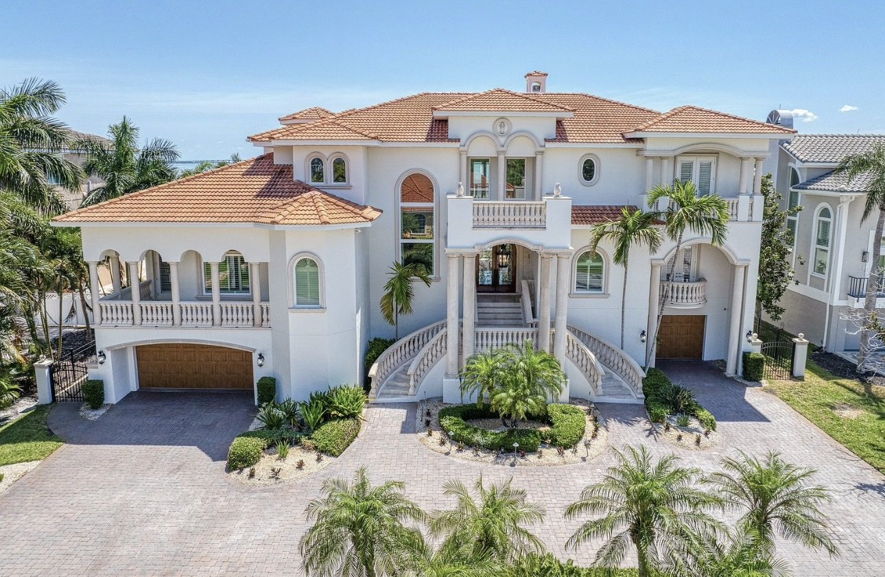Coastal home with tiled roof and landscaped entry